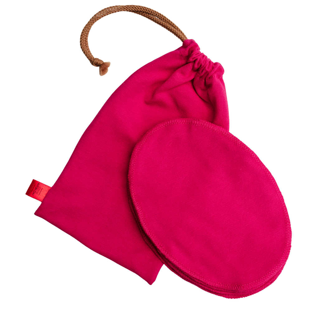 A bright pink drawstring pouch and a matching round pad, both made from organic jersey cotton and ideal for sensitive skin, from Good Wash Day’s Reusable Face Wipes - Pack of 7 + Bag - Small.