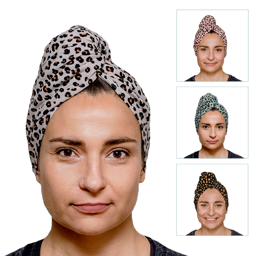 A woman wears "The Leopard Prints" by Good Wash Day, a handcrafted UK head wrap made from organic jersey cotton towel. Available in stunning pink, green, and dark brown shades, it's ideal for sensitive skin.